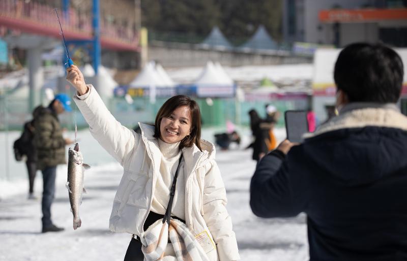 Seorang pengunjung terlihat sangat gembira setelah berhasil menangkap sancheoneo pada tanggal 9 Januari di Festival Hwacheon Sancheoneo yang digelar di Sungai Hwacheon, Hwacheon-gun, Provinsi Gangwon. (Kim Sunjoo) 