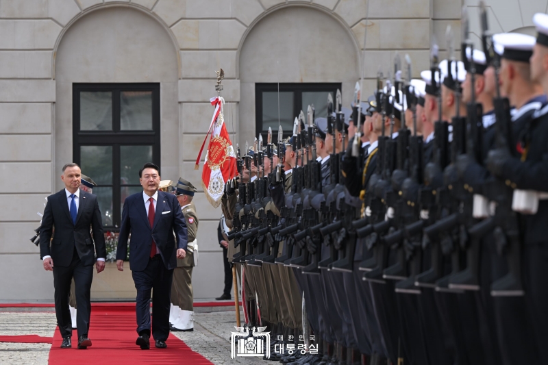 Presiden Yoon Suk Yeol (kedua dari kiri) menginspeksi para penjaga keamanan khusus bersama dengan Presiden Polandia, Andrzej Duda pada tanggal 13 Juli (waktu setempat) di Istana Presiden Polandia yang terletak di Warsawa. 