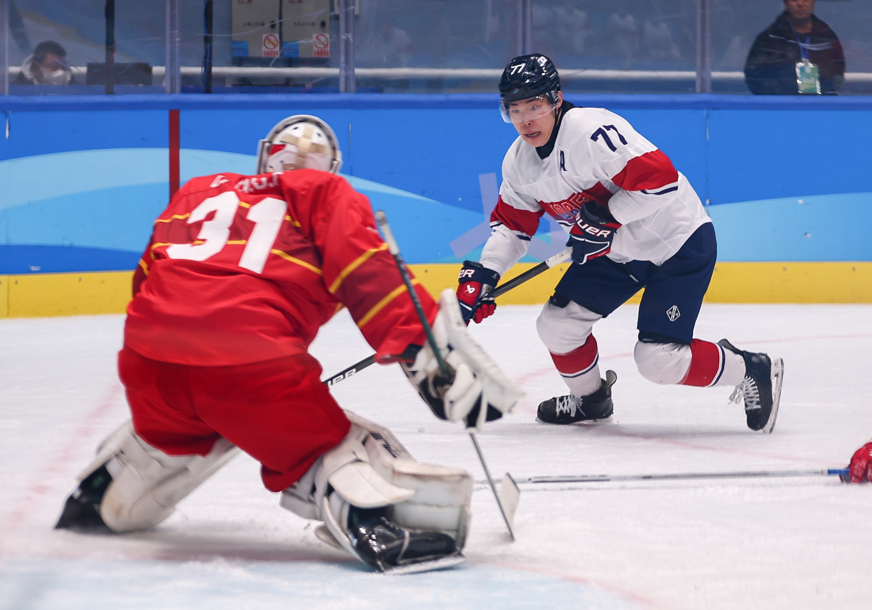 Lee Chongmin terlihat sedang mencoba melewati lawan dalam pertandingan penyisihan Grup A hoki es putra Pesta Olahraga Musim Dingin Asia yang digelar pada tanggal 4 Februari 2025 (waktu setempat) di Harbin Ice Hockey Arena, Harbin, Tiongkok. (Yonhap News)  