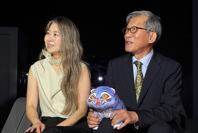 Maggie Kang (kiri), kreator sekaligus kodirektur KPop Demon Hunters, pada tanggal 21 Agustus 2025 menyaksikan video bersama Direktur Jenderal museum, You Hong-june di Galeri Digital Imersif Museum Nasional Korea, Distrik Yongsan, Seoul. (Charles Audouin)