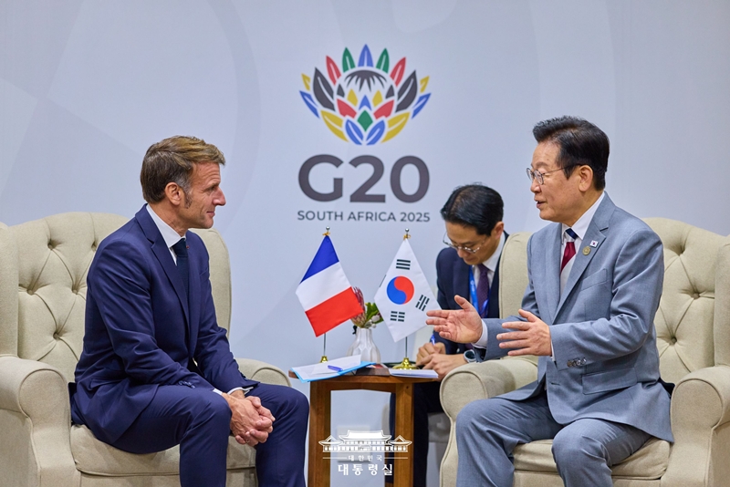 Presiden Lee Jae Myung (kanan) terlihat sedang menggelar pertemuan bilateral dengan Presiden Prancis, Emmanuel Macron, pada tanggal 22 November 2025 (waktu setempat) di Johannesburg Expo Center, Afrika Selatan.  