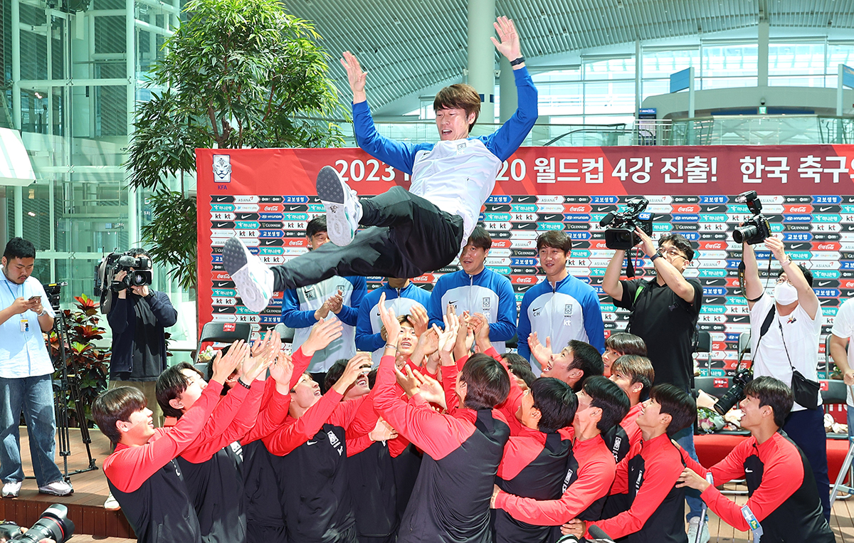 Para atlet tim nasional sepak bola U-20 yang kembali ke Korea pada tanggal 14 Juni mengangkat pelatih Kim Eun-Jung pada acara penyambutan yang digelar di Incheon International Airport Transportation Center 2. Timnas sepak bola U-20 meraih melaju ke babak semifinal Piala Dunia U-20 FIFA 2023. (Yonhap News)