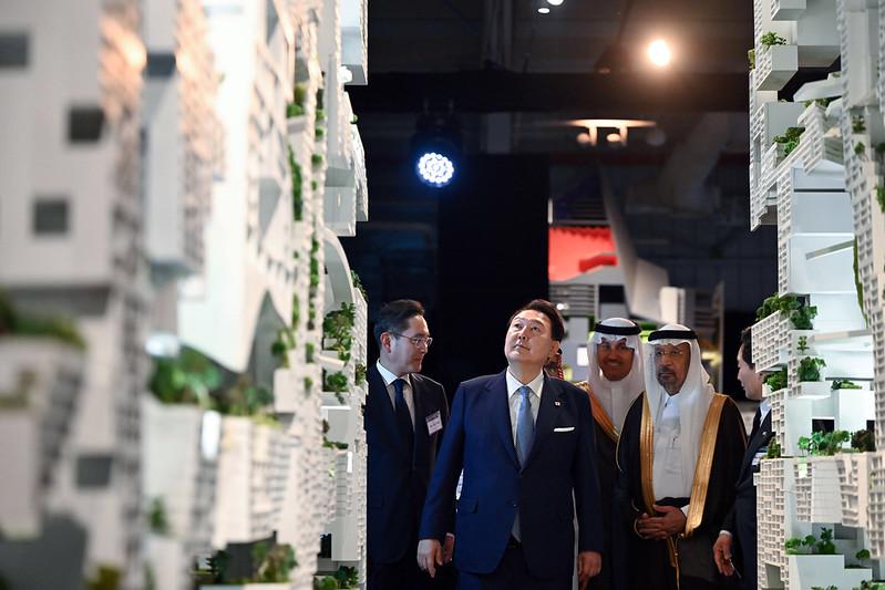 Presiden Yoon Suk Yeol (kedua dari kiri) melihat-lihat pameran bersama Menteri Investasi Arab Saudi, Khalid A. Al-Falih (kedua dari kanan), pada Upacara Peringatan Kerja Sama Konstruksi Korea-Arab Saudi yang ke-50 tahun. Upacara tersebut digelar pada tanggal 23 Oktober (waktu setempat) di Ruang Pameran NEOM yang terletak di pusat Kota Riyadh, Arab Saudi. Dalam kata sambutannya, Presiden Yoon menekankan, Apabila kota-kota baru Arab Saudi, seperti NEOM City, bergabung dengan teknologi konstruksi kota milik Korea, maka kita akan bisa memperlihatkan bersama kepada dunia mengenai model visi kota depan. (Kang Min Seok, Kantor Kepresidenan Republik Korea)