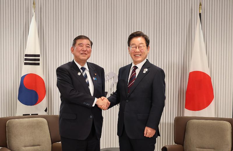 Presiden Lee Jae-myung (kiri) berjabat tangan dengan Perdana Menteri Jepang, Shigeru Ishiba, dalam KTT Korea-Jepang yang digelar sebagai bagian dalam KTT G7 pada tanggal 17 Juni 2025 (waktu setempat) di Kananaskis, Provinsi Alberta, Kanada. 