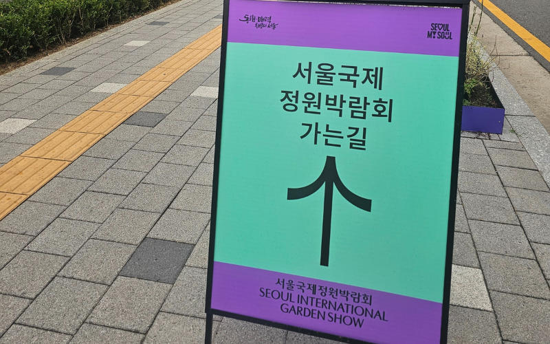 Papan penunjuk arah dari pintu keluar Stasiun Boramae Park. Pengunjung dapat mengikuti arahan yang diberikan untuk menjangkau lokasi Pameran Taman Internasional Seoul. 
