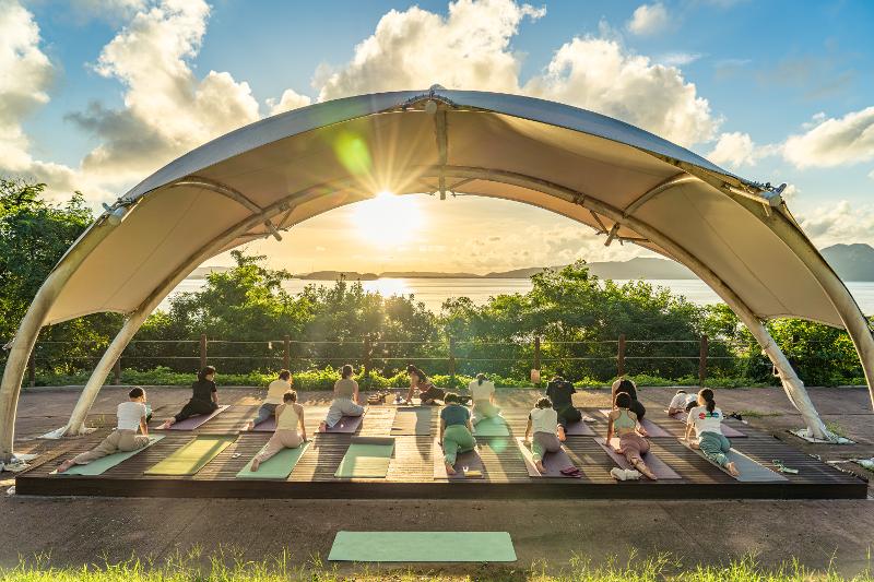 Para peserta Program Wisata Jamsiseom terlihat sedang melakukan yoga dengan latar belakang matahari tenggelam di Ganghwa-gun, Kota Incheon.  