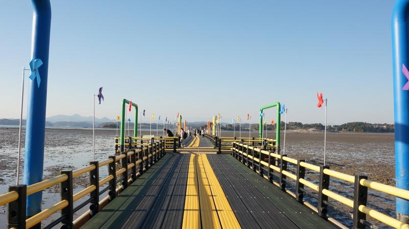 Air laut yang sedang surut memperlihatkan dataran lumpur atau dataran pasang surut laut Sacheon. 