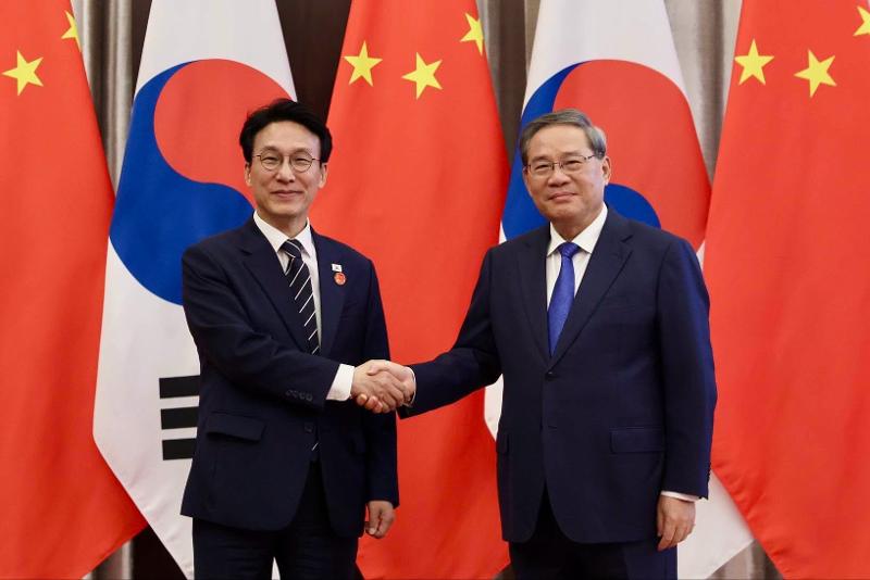 Perdana Menteri Kim Min-seok, yang tengah berkunjung ke Tiongkok, berjabat tangan dengan Perdana Menteri Dewan Negara Tiongkok Li Qiang sebelum pertemuan mereka di Hotel Bangchuidao, Dalian, pada tanggal 23 Juni 2026. (Kantor Perdana Menteri Republik Korea)