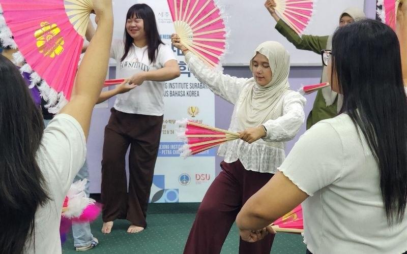 Penulis sedang berlatih salah satu gerakan buchaechum bersama peserta lainnya pada saat mengikuti SCA 2026 pada tanggal 17-20 Juni 2026 di King Sejong Institute Surabaya. 
